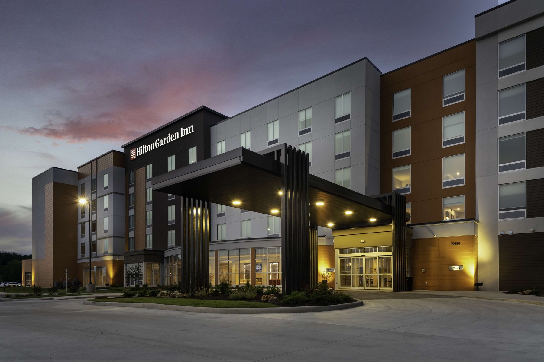 Hilton Garden Inn entrance and porte-cochère at dusk